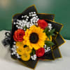 Bouquet of sunflowers, red roses, and white baby's breath in black wrap