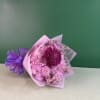 Pink and purple chrysanthemum bouquet wrapped in translucent paper