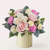Pink and white rose bouquet in a gold-striped vase
