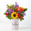 Mixed bouquet in a birthday vase with a sunflower, roses, and purple blooms