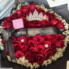 Bouquet of red roses with a black ribbon and crown topper