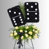 Black floral standing tribute with yellow and white roses on an easel