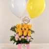 Yellow and pink roses in a pink box with balloons and chocolates