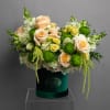 Peach and white roses with green pompons in a velvet box