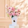 Pink mixed flower arrangement in a white gift box with ribbon