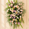 Tall pastel floral standing spray with pink, white, and lavender blooms