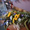 Mixed bouquet with sunflowers, blue flowers, and white filler flowers