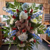 Large patriotic standing floral spray with red, white, and blue flowers