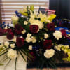 Mixed bouquet with red roses, white lilies, and white carnations
