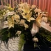 White lily and carnation arrangement with ribbon bows