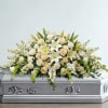 White floral spray on a silver casket