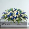 White and blue floral spray on a silver casket