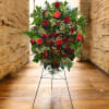 Large red floral standing spray on a metal easel