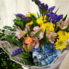 Mixed bouquet with blue hydrangea, yellow daisies, pink lilies, and purple filler flowers