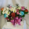 Mixed bouquet of roses, daisies, carnations, and alstroemeria in a wooden box