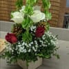 White and red roses arranged with baby's breath in a wooden box