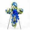 Cross-shaped floral standing spray with blue, white, and green flowers