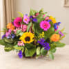 Mixed bouquet in a wicker basket with bright gerbera daisies and roses