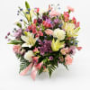 Mixed bouquet of lilies, carnations, and chrysanthemums in a vase