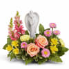 Floral arrangement with roses, daisies, and a praying angel figurine