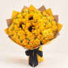 Bouquet of yellow roses and sunflowers wrapped in yellow and brown paper