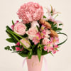 Pink roses and mixed blooms in a pink hatbox with ribbon