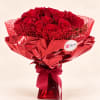 Bouquet of red roses wrapped in shiny red paper with a ribbon