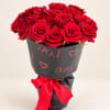 Bouquet of red roses wrapped in black paper with a red bow