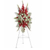 Red and white funeral spray on a metal easel