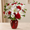 Red roses and white lilies in a red glass vase