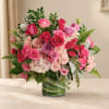 Pink and lavender rose bouquet in a green glass vase