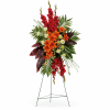 Tall floral standing spray with red and orange flowers on a metal easel