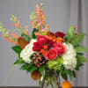 Mixed bouquet of roses and hydrangeas in a glass vase