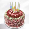 Round pink floral birthday cake with candles and a Happy Birthday topper