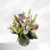 Pink and white bouquet with lilies and roses in a glass vase