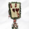 Floral standing tribute with red and white flowers on a green frame