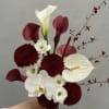 Bouquet with white orchids, burgundy calla lilies, and dark red mums