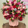 Pink and red rose bouquet in a blush geometric vase