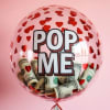 Clear balloon with red hearts and rolled dollar bills inside, labeled POP ME.