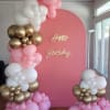 Pink birthday backdrop with white, pink, and gold balloon clusters