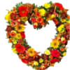 Heart-shaped floral wreath with red, yellow, and orange blooms