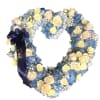 Heart-shaped floral wreath with blue and cream roses and a navy ribbon