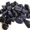 Pile of polished dark blue-black stones with glittery flecks