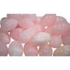 Cluster of pale pink polished stones on a white background