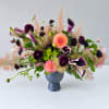 Purple calla lilies and pink dahlias in a blue vase
