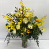 Yellow and white floral arrangement in a clear glass vase