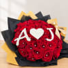 Red rose bouquet with white "A ♥ J" lettering and a gold ribbon