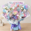 Pastel bouquet of roses and lilies with a purple ribbon and butterfly accents
