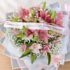 Pink lilies and baby's breath bouquet with a ribbon banner