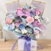 Pastel bouquet of lilies and roses in a gift box with a purple ribbon